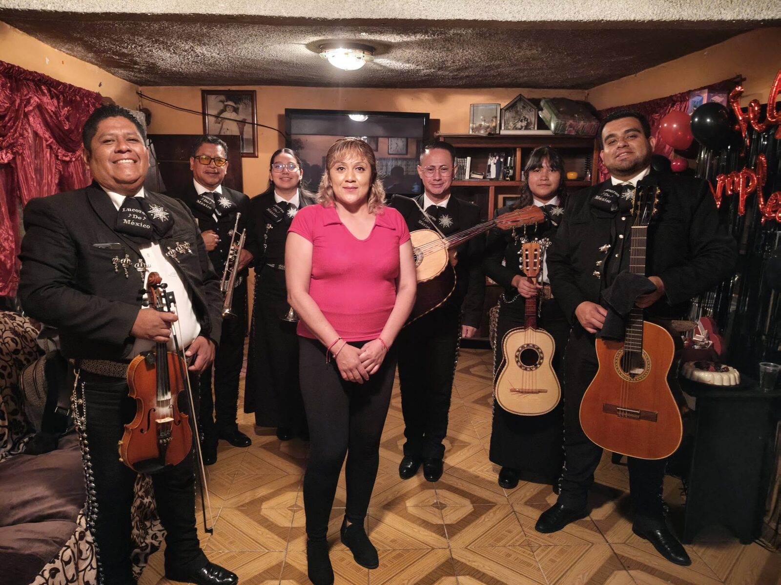 Mariachi Luceros de México con clienta en sala decorada