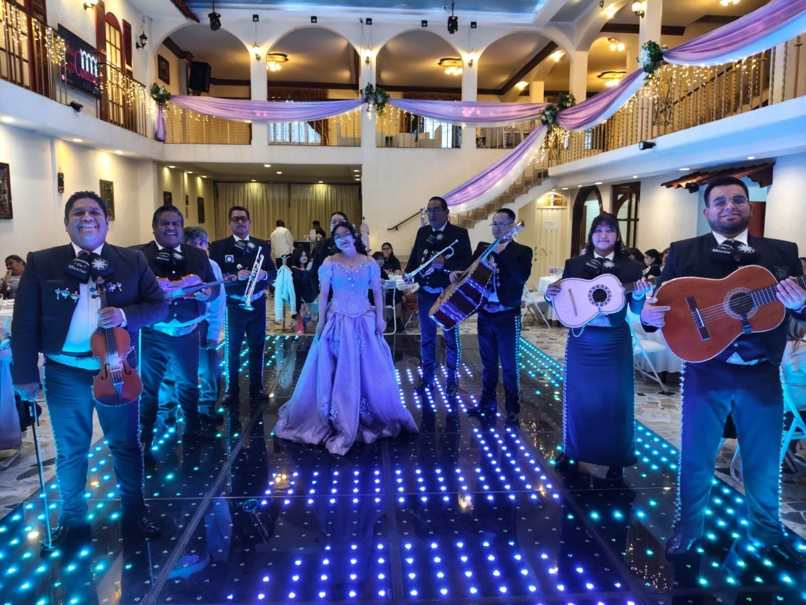 Mariachi con quinceañera en salón con balcones